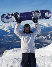 Niall Nicholls holding a snowboard
